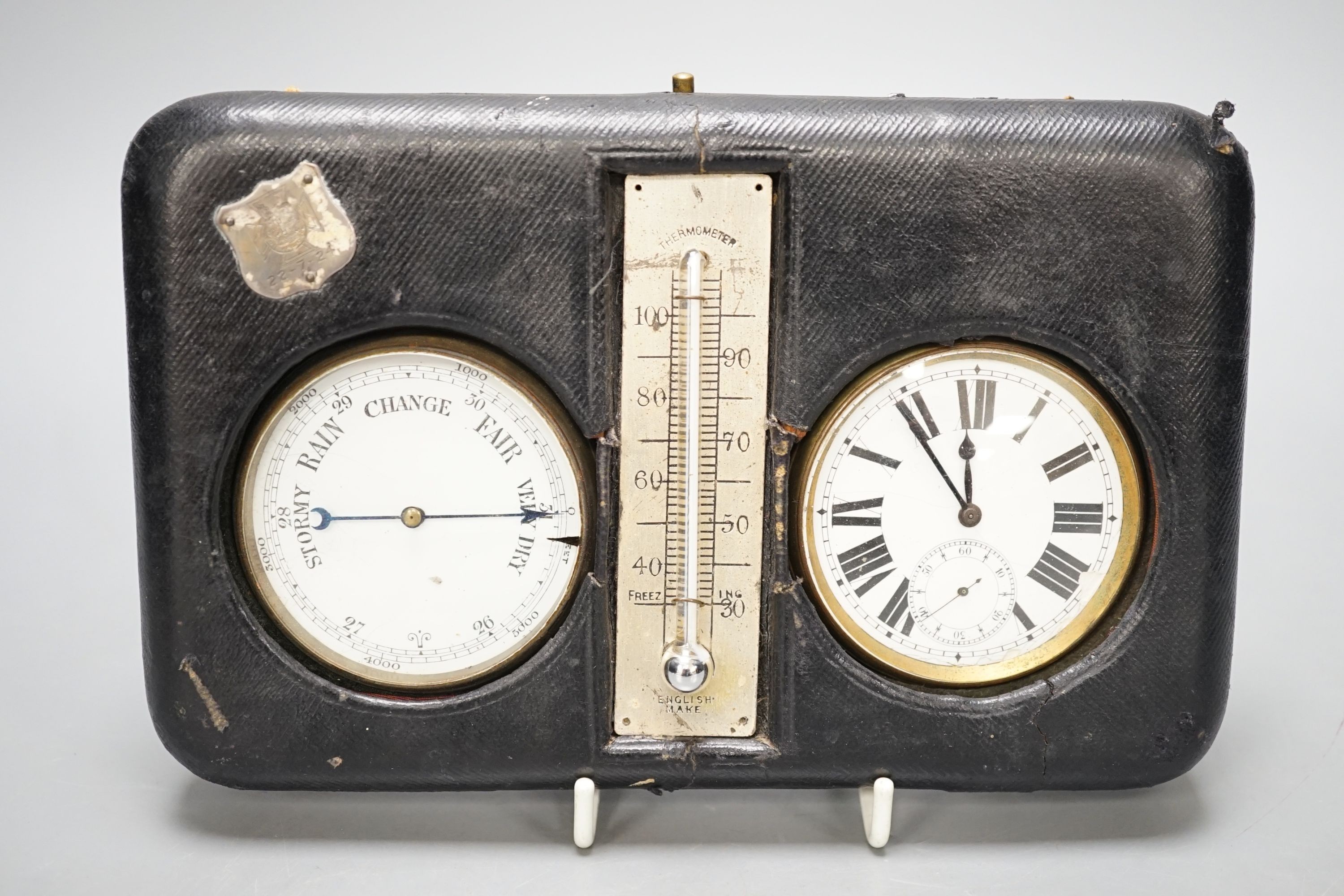 A leather cased pocket watch and barometer with central thermometer, 19.5 cm wide x 13 cms high.